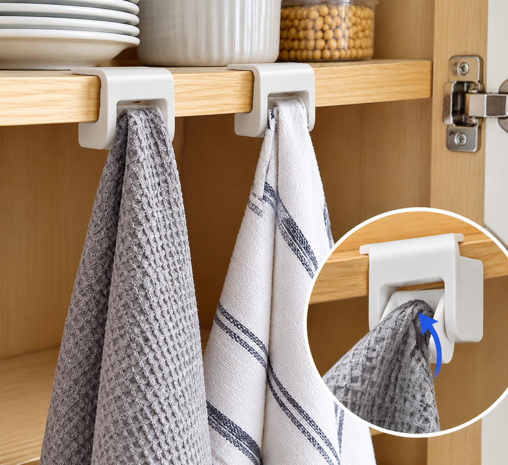 White cabinet storage clips holding kitchen towels beneath a wooden shelf